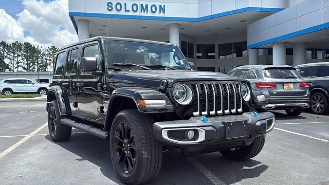 2022 Jeep Wrangler 4xe Unlimited Sahara in Black — front three-quarter view