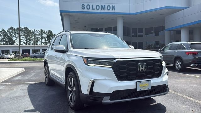 2023 Honda Pilot Touring in White — front three-quarter view